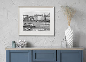 Boats and spreading wakes fill the foreground of a Venice waterfront view