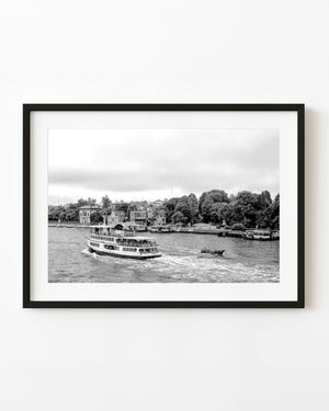 Passenger ferry leaves a curved wake on Venice Giudecca Canal in black and white