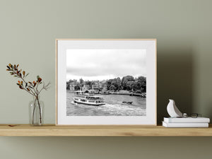 Monochrome Venice canal scene with a passenger ferry and sweeping wake