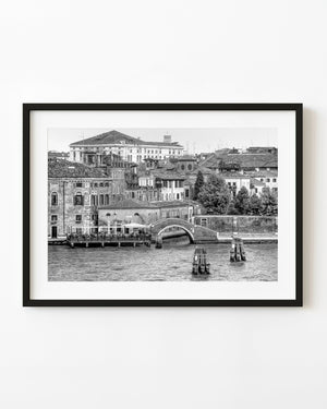 Venice waterfront bridge and layered historic buildings in black and white