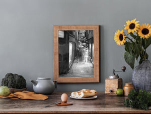 Motion-blurred walkers pass weathered walls and stone paving in Venice