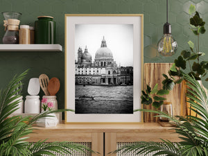 Ornate domes and statues above Venetian buildings beside open water