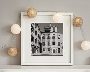 Rows of windows and small balconies on weathered Venice plaster walls