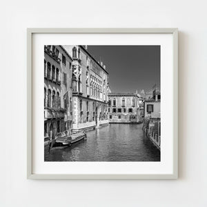 Black and white photo of Venice canal with historic buildings