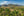 Palm trees overlooking farmland and limestone hills in Viñales Valley.