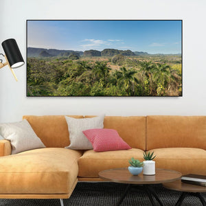 Wide Cuban valley view with red-earth fields and green forested hills