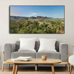 Tropical vegetation fills the foreground of a broad Vinales Valley landscape