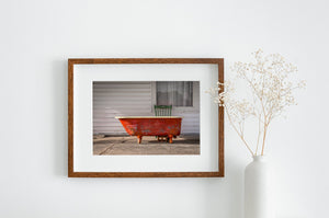 Weathered vintage tub under open skies, reflecting the timeless allure of America’s historic highway.