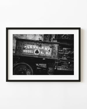 Weathered Cleveland Model 92 machinery sign and metal parts in black and white