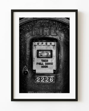Vintage fire alarm call box numbered 2226 photographed in black and white
