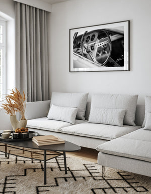 Black and white image of vintage muscle car cockpit