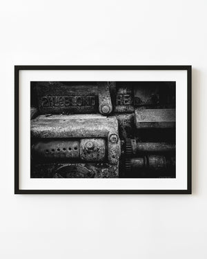 Black and white detail of vintage industrial machinery and worn metal.