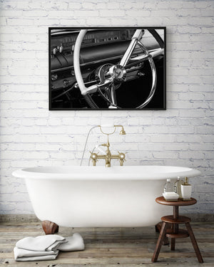 Polished chrome spokes and pale rim on an old car steering wheel.