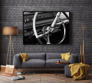 Classic dashboard gauges behind a vintage steering wheel.