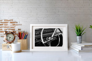 Detailed view of a vintage car steering wheel and instrument panel.