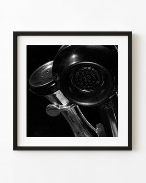 Vintage telephone receiver and polished metal in black and white.