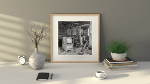 Weathered television surrounded by debris and peeling interior walls.