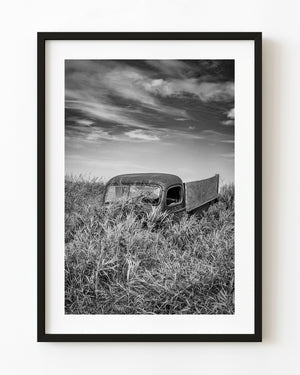 Vintage truck surrounded by tall Saskatchewan grass in black and white.