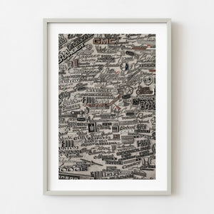 Vintage car emblems arranged in a large wall collage
