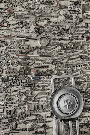 Classic automotive badges and hubcap monochrome photograph