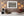 Wall covered with antique car nameplates