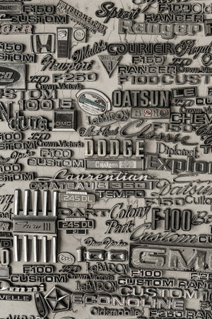 Classic car badges and chrome nameplates wall display