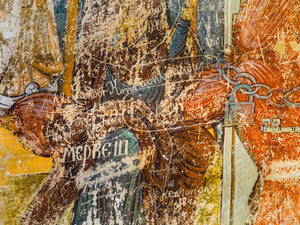 Close detail of scratched lettering over red ochre and blue monastery wall paintings