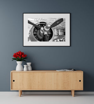 Black and white aviation detail with a polished propeller hub and engine cylinders