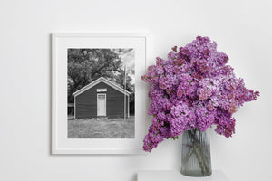 White-trimmed doorway and clapboard walls on a historic schoolhouse.