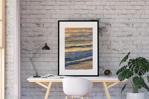Colour seascape showing gentle surf and warm shimmering water.
