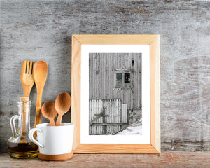Peeling white barn boards and a broken window in Norway