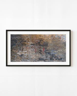 Weathered Beijing brick wall with faded red and white Chinese characters