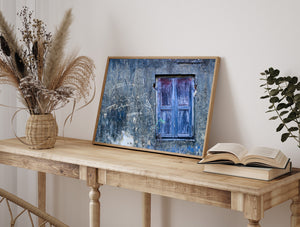 Closed blue wooden shutter against a textured grey wall