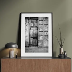 Weathered doorway and textured masonry in monochrome