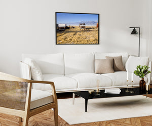 Golden field with an old farm truck and snow-covered mountain range
