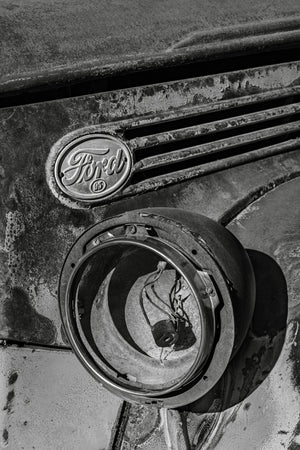 Old Ford grille with a missing headlight and exposed wiring