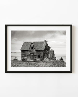 Weathered wooden coastal house in Gaspé photographed in black and white