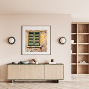 Weathered Tuscan window shutters above exposed brickwork