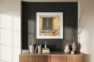 Old wooden shutters with flaking green paint and textured masonry