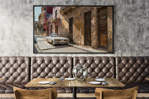 Cuban streetscape with aged wooden doors and a classic white car