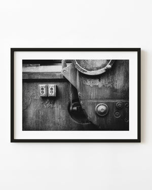 Weathered industrial machine controls and metal surfaces in black and white