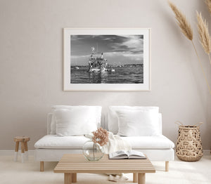 Black and white harbour scene with a weathered yacht stern