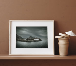 Norwegian coastal scene with a weathered building and rippled water