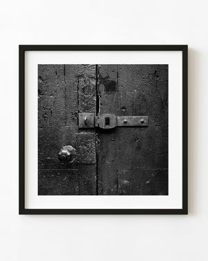 Weathered London door with a metal latch in black and white