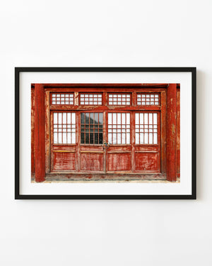 Weathered red wooden doorway at the Great Wall of China