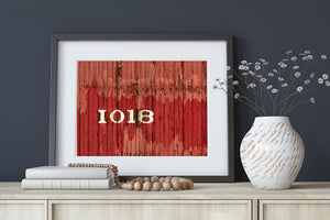 Textured red wooden railway car with faded paint and white numerals