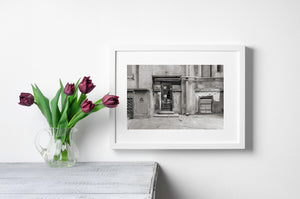 Weathered Romanian architecture with a narrow door and rough plaster walls