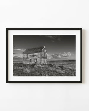 Weathered Saskatchewan prairie farmhouse in black and white