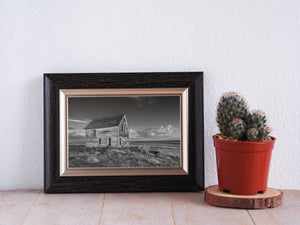 Saskatchewan rural photograph with an abandoned-looking wooden house beneath clouds