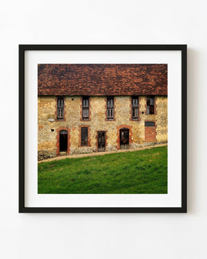 Weathered stone and red brick building in rural France